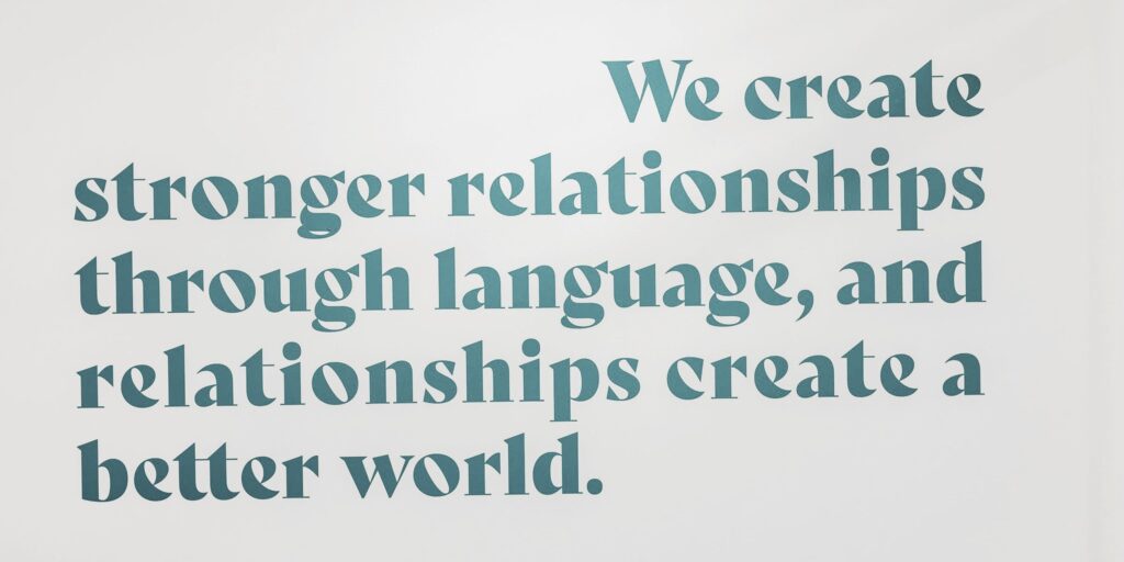 Close-up of a wall featuring Interpro's mission statement: “We create stronger relationships through language...”
