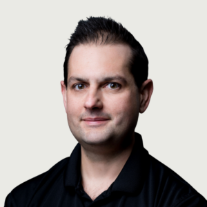 Man in black polo on white background, Nick Strozza, Interpro CEO