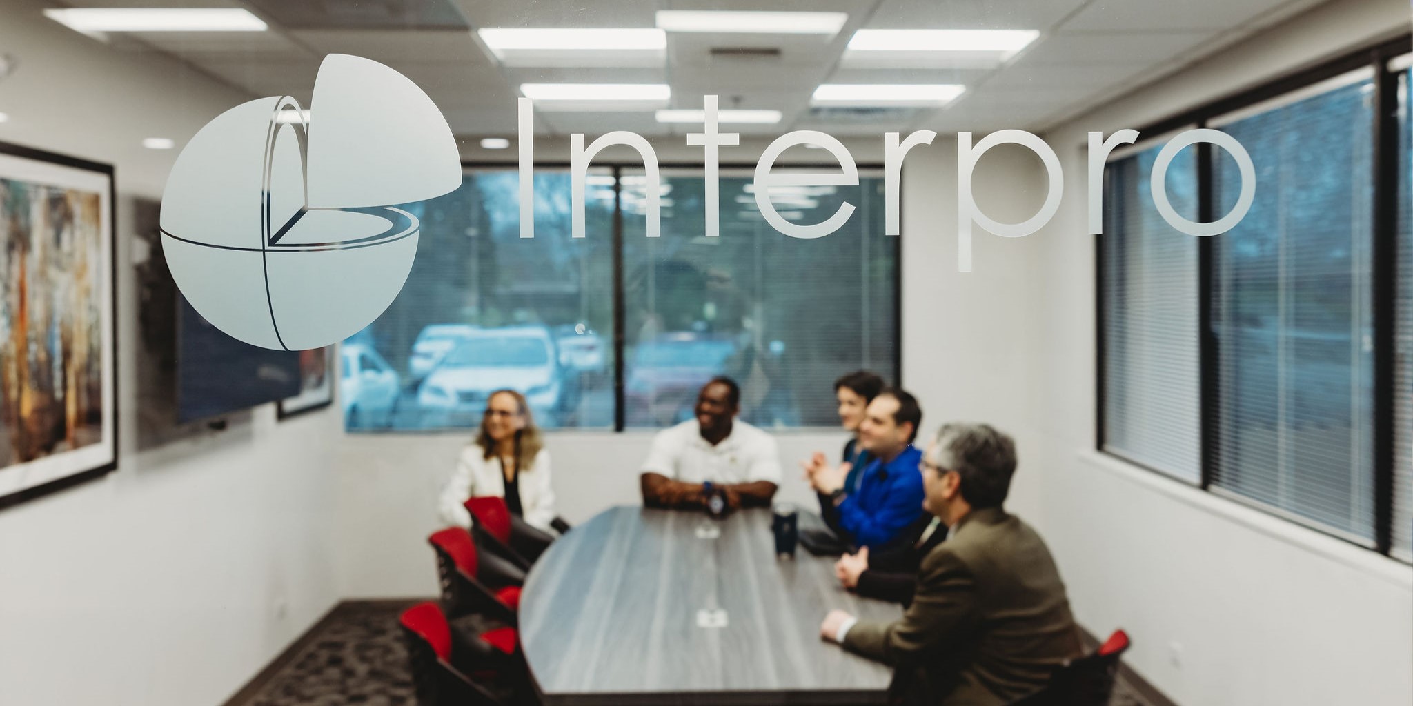 Conference room pictured through glass with Interpro logo