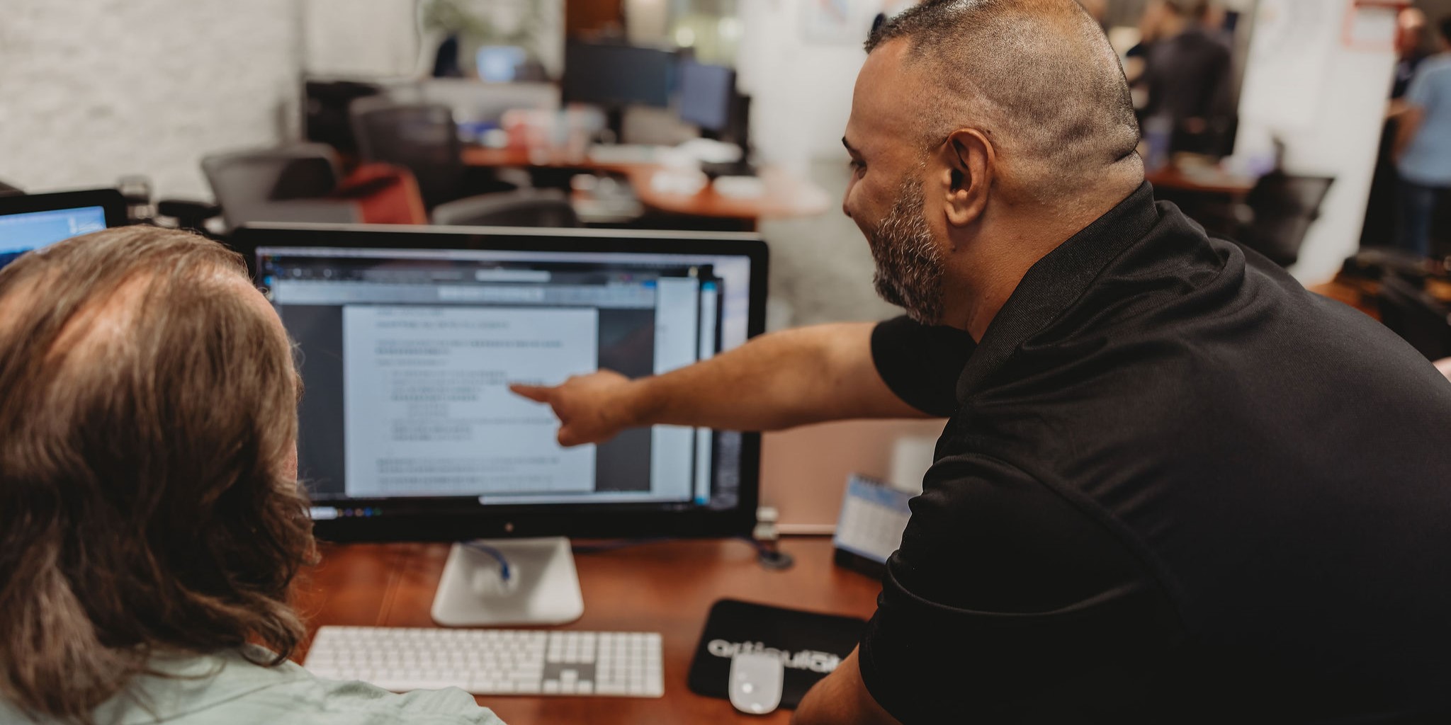 Two Interpro team members reviewing AI-generated translation output together on-screen to ensure accuracy and clarity through human oversight for ethical AI translation.