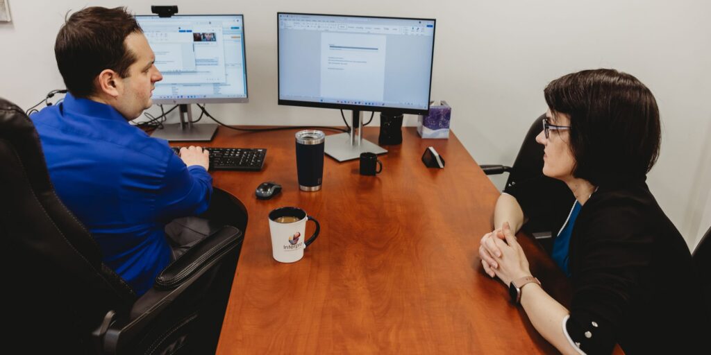 Interpro team reviewing translation output on dual monitors