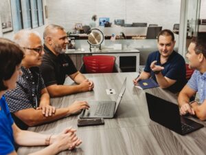 Localization experts sitting at conference room table.