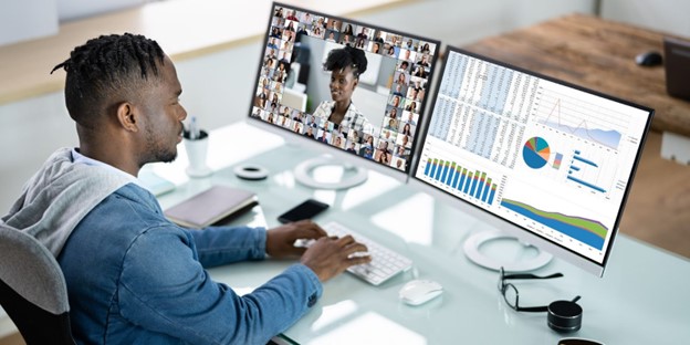 Professional reviewing Copilot for translation risks on dual monitors with multilingual content and analytics