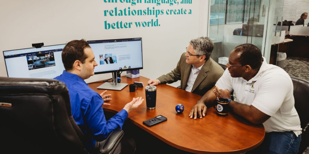 Interpro leadership team meeting with clients to discuss AI translation strategy in a conference room