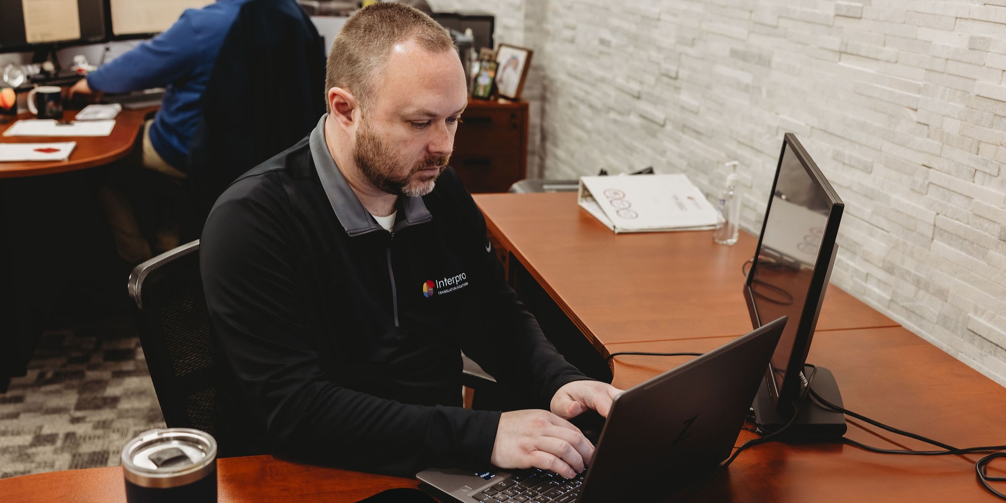 Localization specialist reviewing translation workflow on a laptop