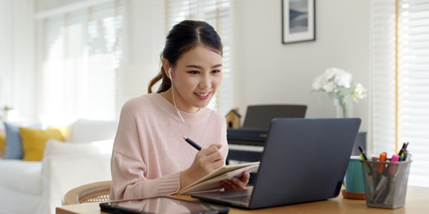 eLearning translation workflow review with laptop and notes
