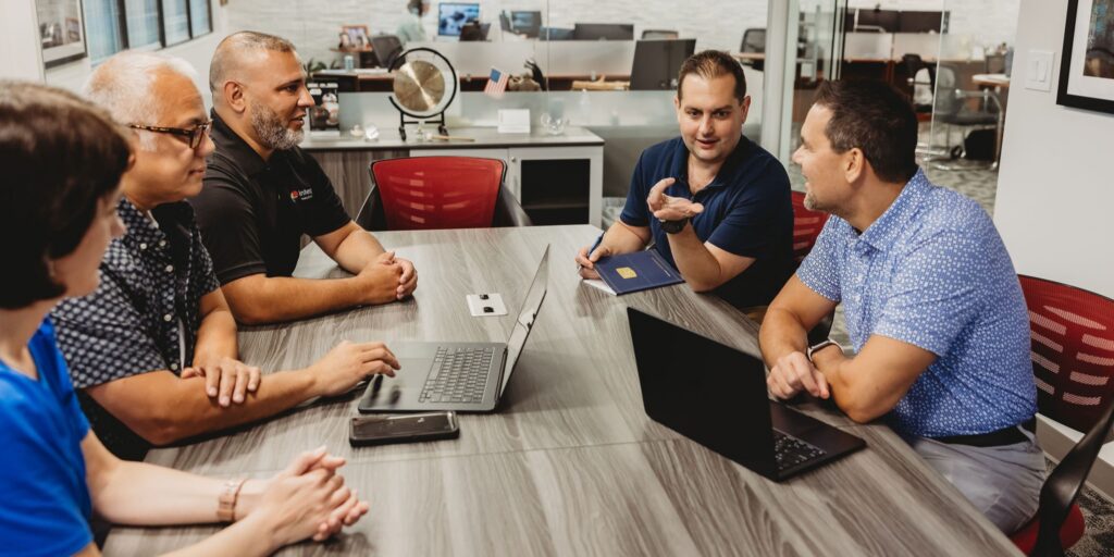 Team meeting discussing eLearning translation quality and compliance for multilingual training programs